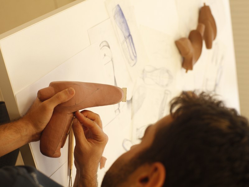 Response Ortho industrial designer shaping a clay model of an instrument handle