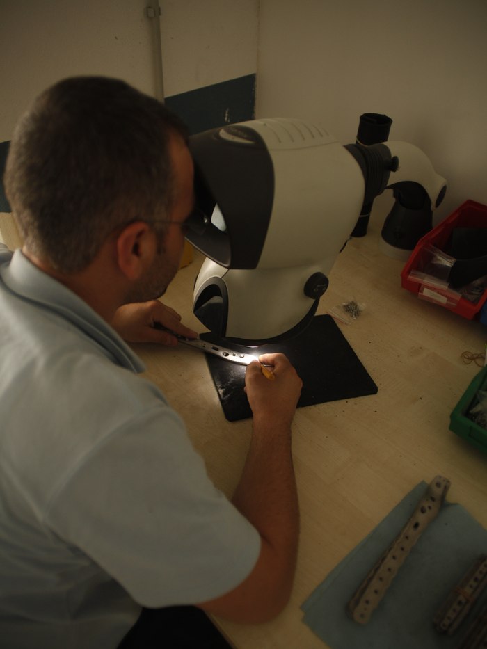 Response Ortho quality control inspection of a plate under a microscope